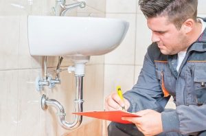 Plumber working on sink