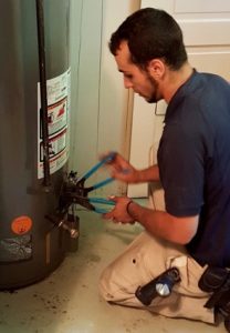 plumber working on water heater